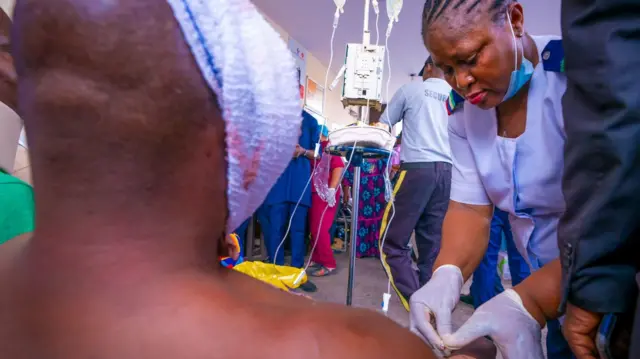 A nurse treating someone wounded in the collision in Lagos, Nigeria