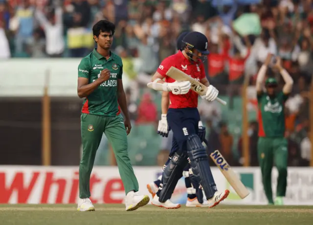 Bangladesh's Hasan Mahmud celebrates after taking the wicket of England's Sam Curran