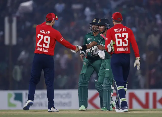 Bangladesh's Shakib Al Hasan and Afif Hossain with England's Dawid Malan and Jos Buttler after winning the match