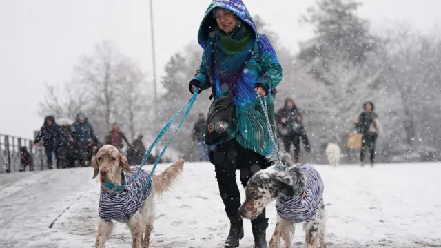 People arrive on the first day of the Crufts Dog Show at the National Exhibition Centre (NEC) in Birmingham