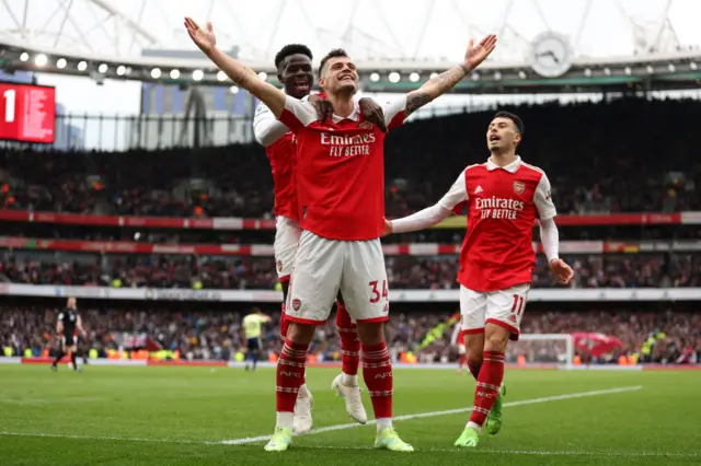 Granit Xhaka of Arsenal celebrates with teammate Bukayo Saka