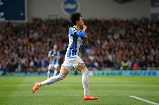 Kaoru Mitoma of Brighton & Hove Albion celebrates after scoring the team's first goal during the Premier League match between Brighton & Hove Albion and Brentford FC