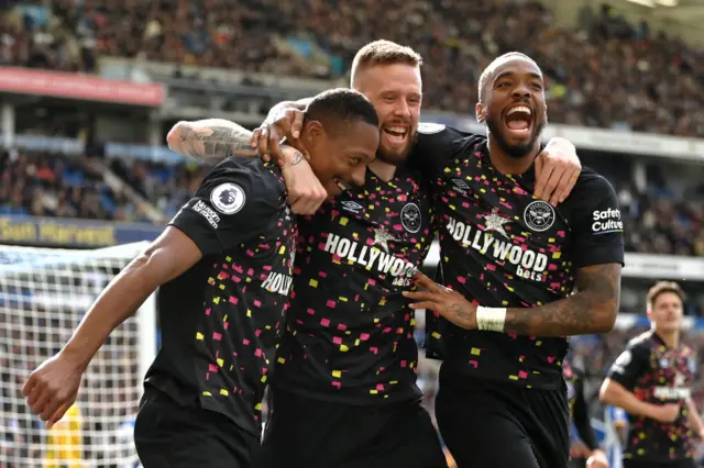 Ethan Pinnock of Brentford celebrates with teammates Pontus Jansson and Ivan Toney after scoring the team's third goal