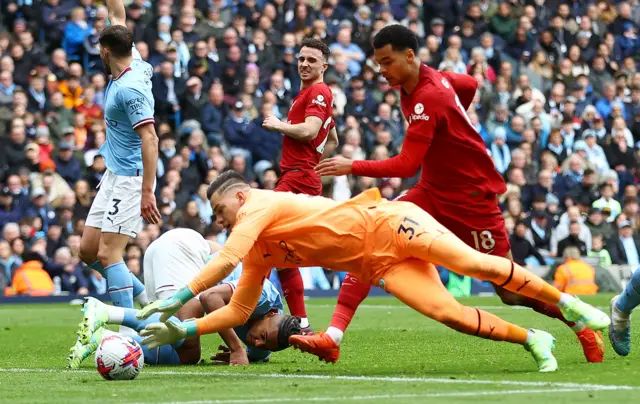 Man City keeper Ederson denies Liverpool forward Cody Gakpo.