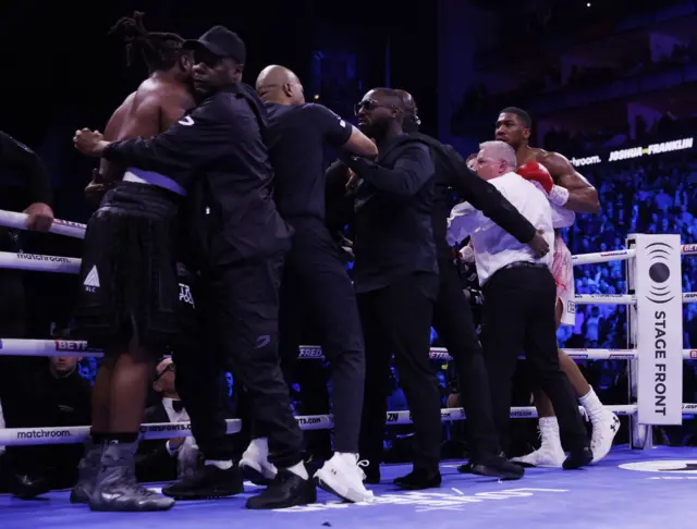 Anthony Joshua and Jermaine Franklin are seperated by security