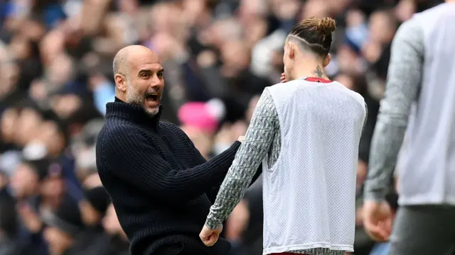 Pep Guardiola and Kostas Tsimikas