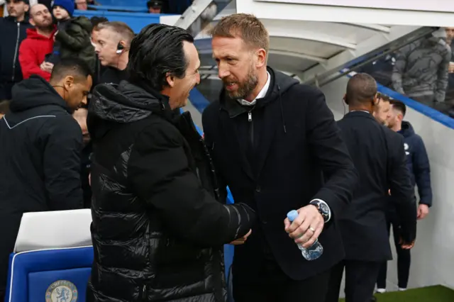 Graham Potter, Manager of Chelsea, shakes hands with Unai Emery, Manager of Aston Villa,