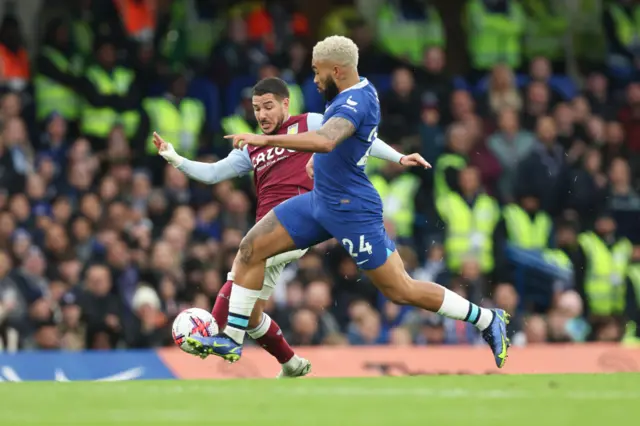 Reece James of Chelsea tackles Emiliano Buendia of Aston Villa