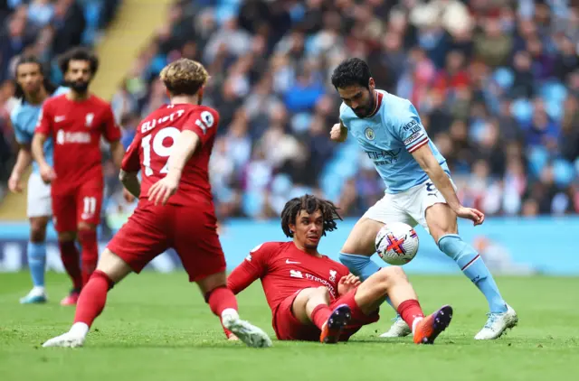 Man City and Liverpool players battle for possession.