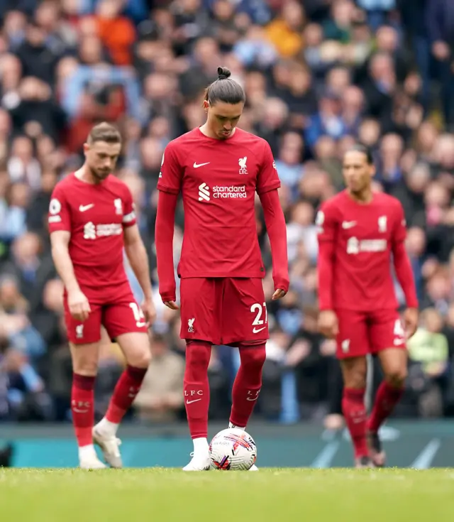 Liverpool players commiserate after conceding a fourth goal to Man City.