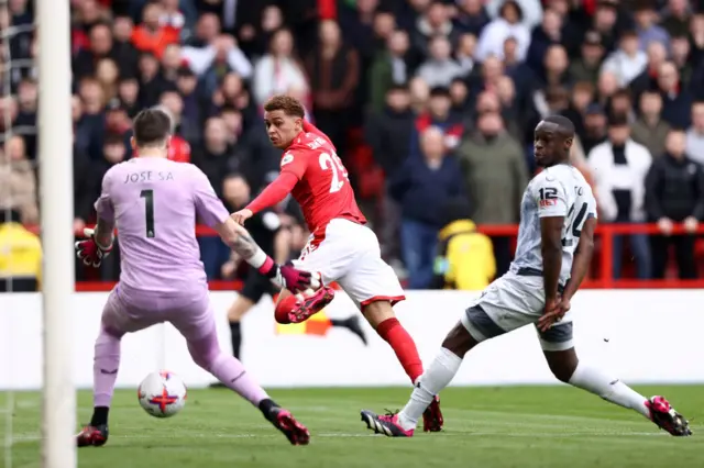 Brennan Johnson of Nottingham Forest scores the team's first goal past Jose Sa of Wolverhampton Wanderers during the Premier League match between Nottingham Forest and Wolverhampton Wanderers