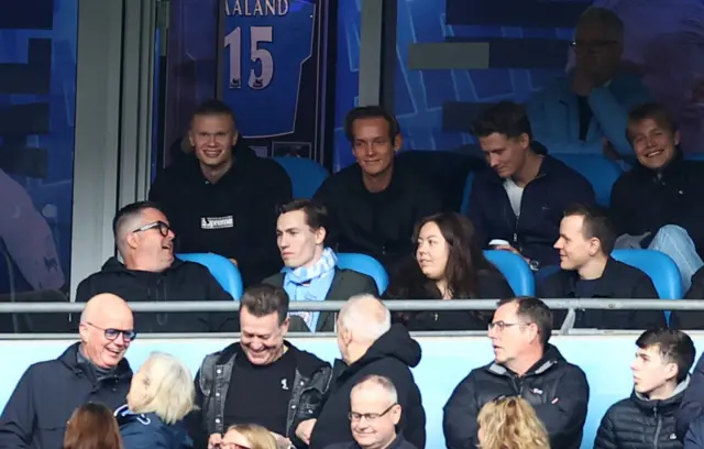 Injured Man City striker Erling Haaland watches on from the stands.