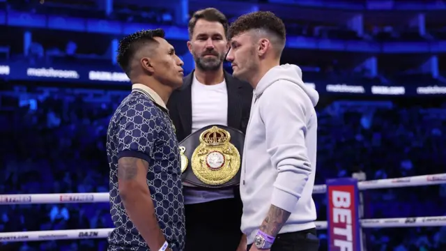 Mauricio Lara faces off with Leigh Wood in the ring