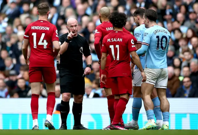 Fabinho is spoken to by referee Simon Hooper.