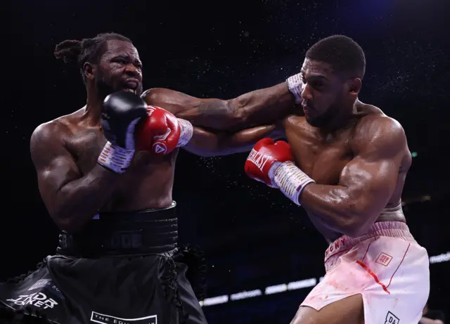 Anthony Joshua and Jermaine Franklin throw punches