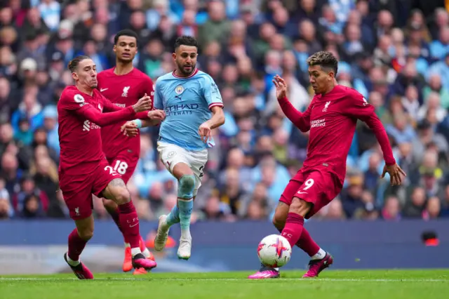 Riyad Mahrez dribbles through a host of Liverpool defenders.