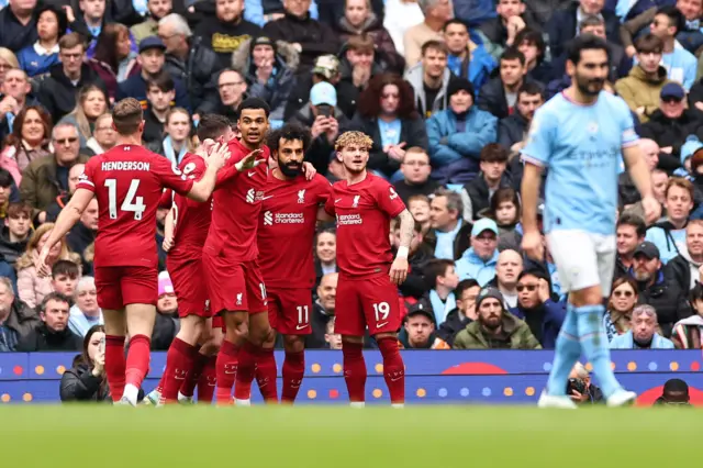 Liverpool players celebrate scoring the opening goal against Man City.