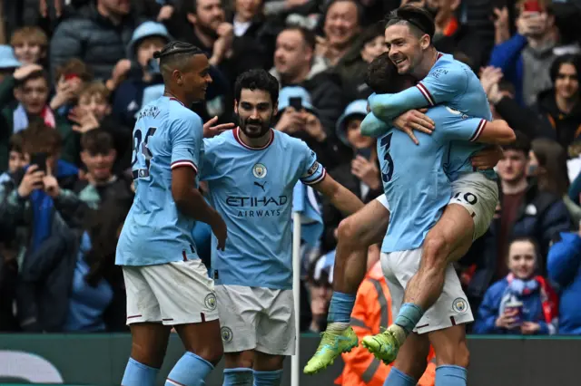 Man City players celebrate scoring a fourth goal v Liverpool.