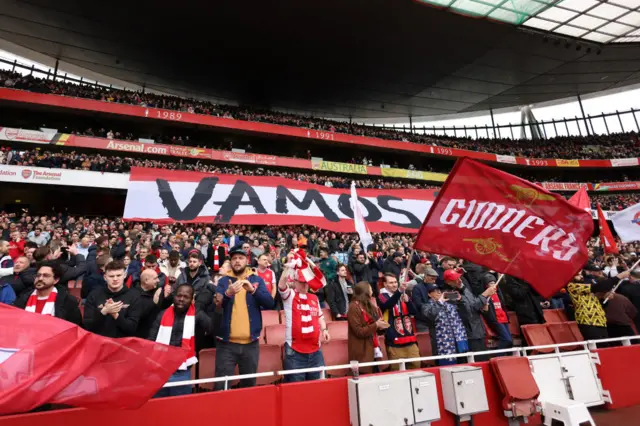 Arsenal fans display a banner saying 'Vamos' with an image of Mikel Arteta, Manager of Arsenal, prior to the Premier League match between Arsenal FC and Leeds United