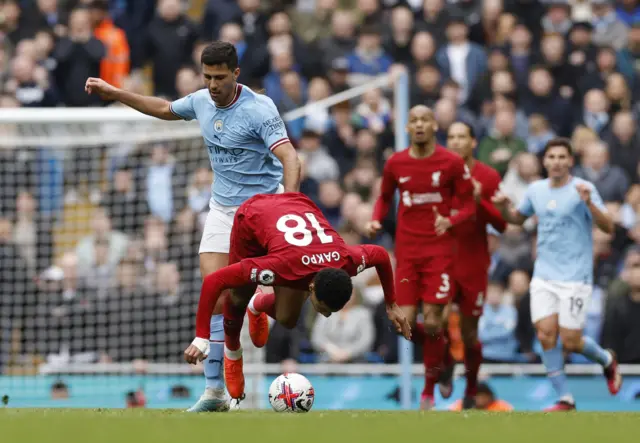 Man City's Rodri fouls Liverpool's Cody Gakpo.