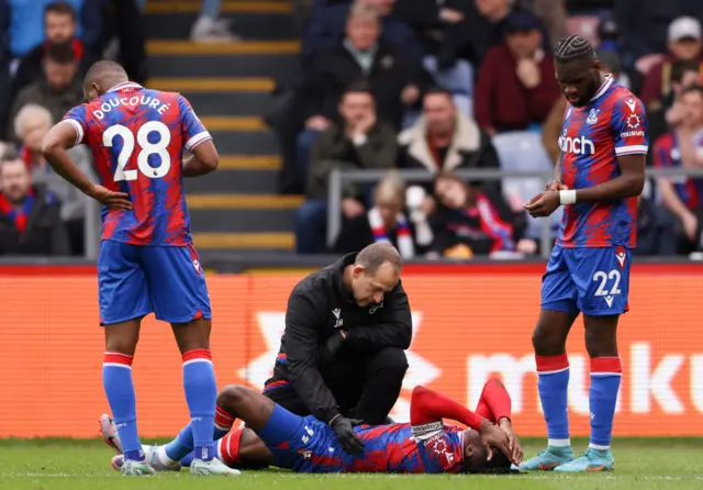 Wilfried Zaha of Crystal Palace receives medical treatment during the Premier League match between Crystal Palace and Leicester City