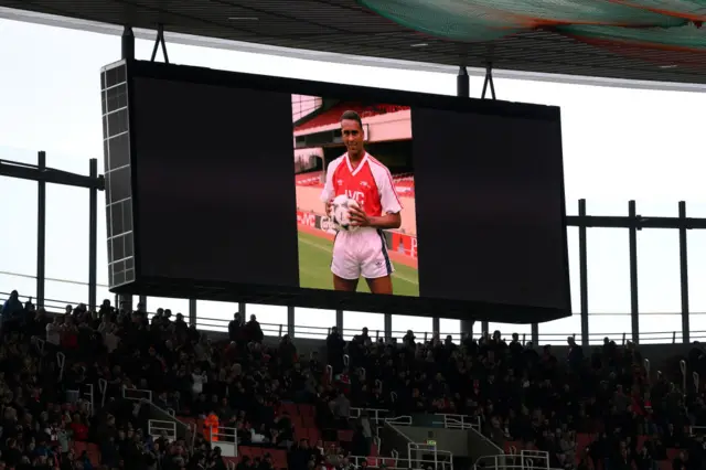 An image of David Rocastle is displayed on the big screen to mark his passing 22 years ago prior to the Premier League match between Arsenal FC and Leeds United