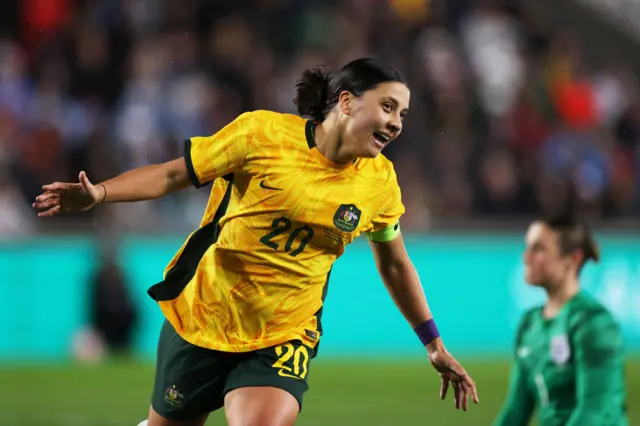 Sam Kerr celebrates scoring against England.