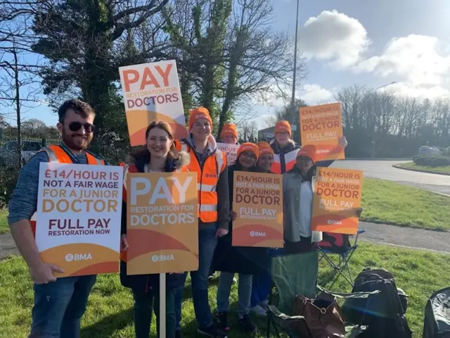 Doctors holding signs