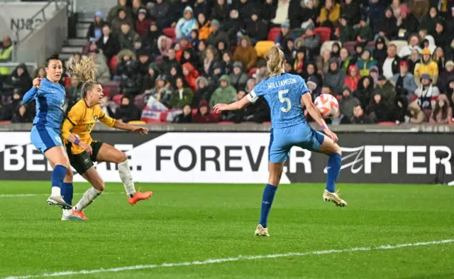 The ball deflects off Leah Williamson for Australia's second goal.