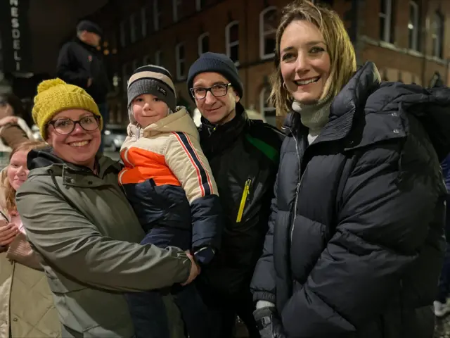 A mother, father and their child pictured with the BBC's Lucy Hockings