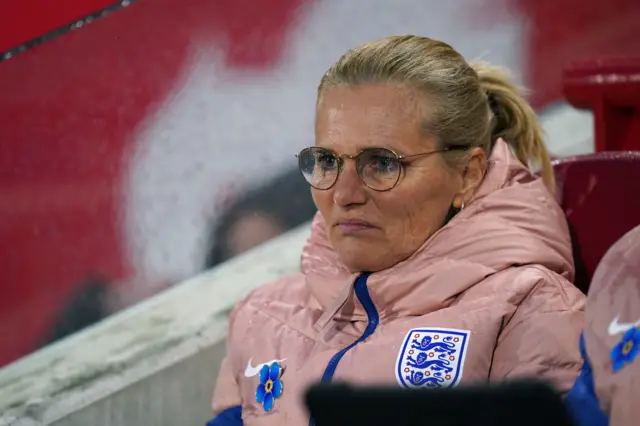 Sarina Wiegman watches on from the sidelines.