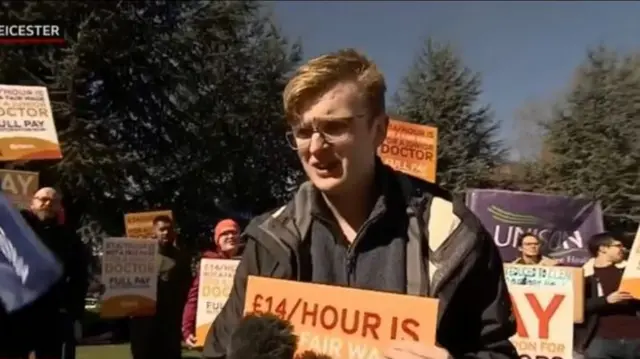 Ben speaking to reporter on picket line