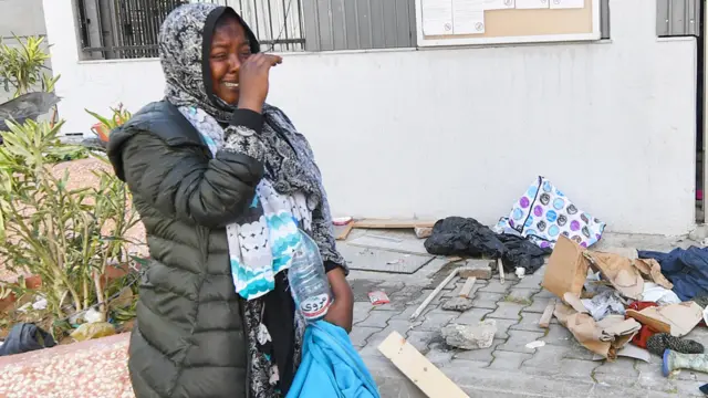 A migrant woman cries in front of the UNHCR headquarters in Tunis after the police dismantled a camp for migrants and refugees from sub-Saharan African countries - 11 April 2023