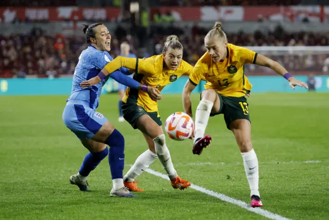 Australia defenders crowd out Lucy Bronze.