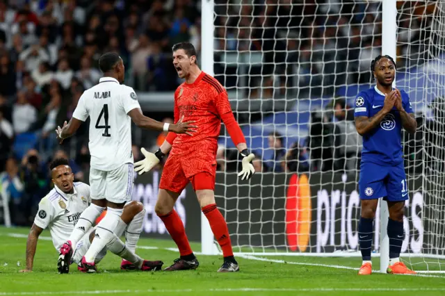 Real Madrid goalkeeper Thibaut Courtois celebrates making a save against Chelsea