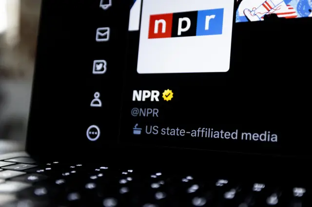 Laptop screen with NPR's twitter account open, showing a tag saying "US state-affiliated media"