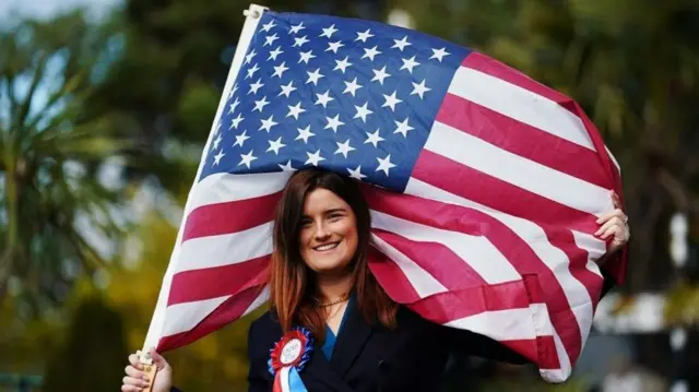 Andrea McKevitt holds a US flag