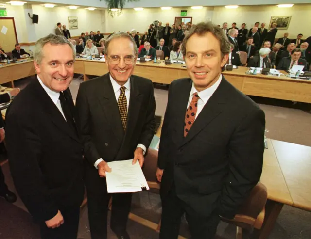 Three men smiling