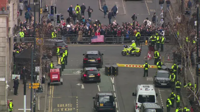 Cars in the street and police surrounding traffic