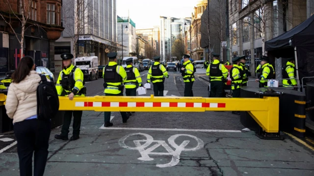 Police officers guard the entrance to the Grand Central Hotel