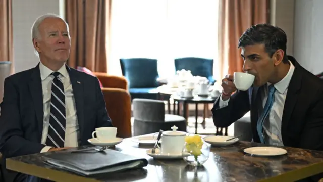 US President Joe Biden (L) reacts as he meets with Britain's Prime Minister Rishi Sunak in Belfast on April 12, 2023, as part of a four day trip to Northern Ireland and Ireland for the 25th anniversary commemorations of the "Good Friday Agreement".