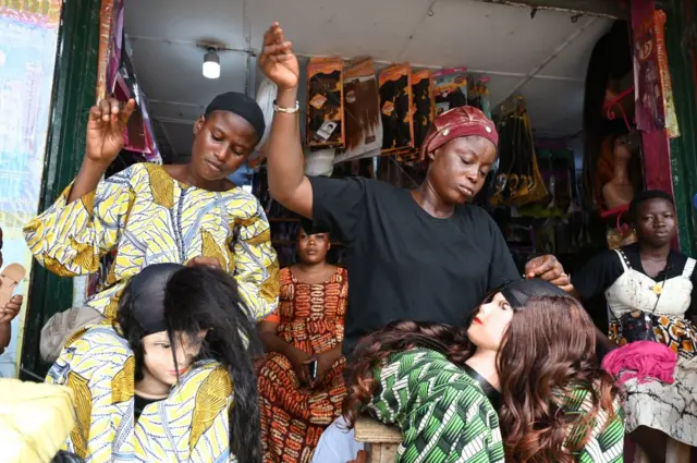 Women sewing wigs