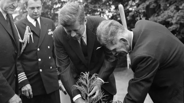 President John F Kennedy plants a tree at Aras an Uachtarain during his visit to Ireland