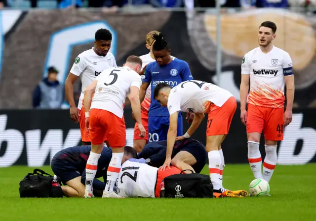 West Ham United's Angelo Ogbonna receives medical attention after sustaining an injury