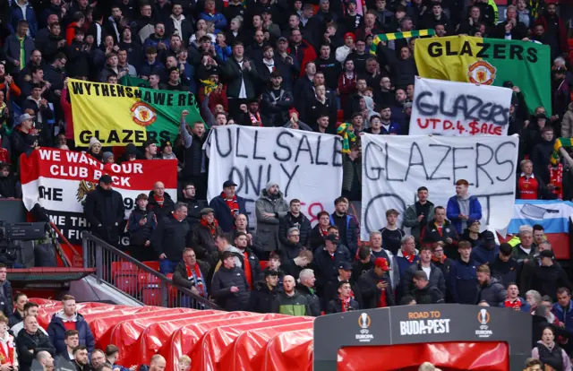 Manchester United fans display banners in protest of the Glazer family’s ownership of the club ahead of the match