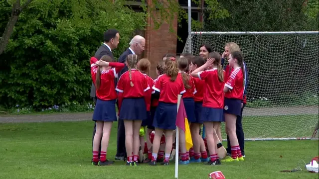 Varadkar and Biden with girls playing camogie