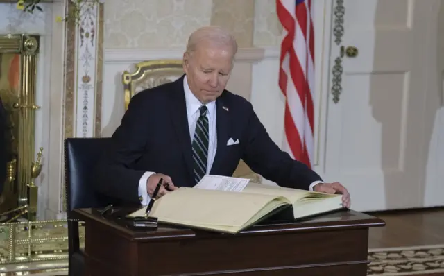 Biden signing the visitor book in Irish President's House