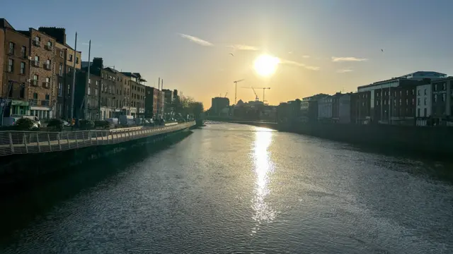 Sun over river in Dublin