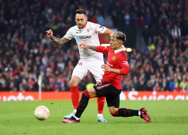 Sevilla's Lucas Ocampos in action with Manchester United's Lisandro Martinez