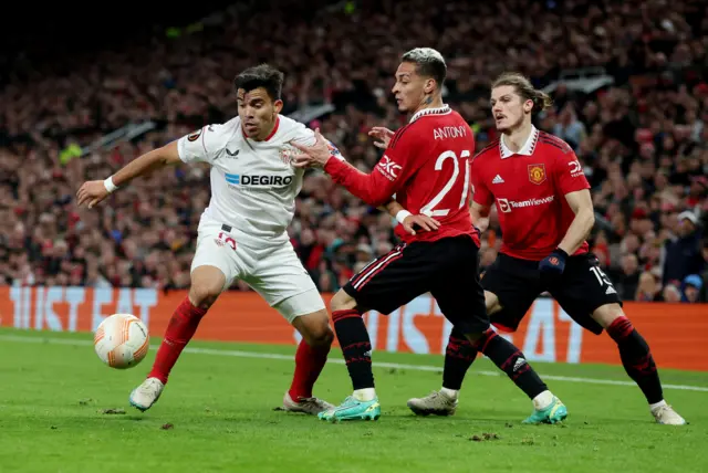 Manchester United's Antony and Marcel Sabitzer in action with Sevilla's Marcos Acuna